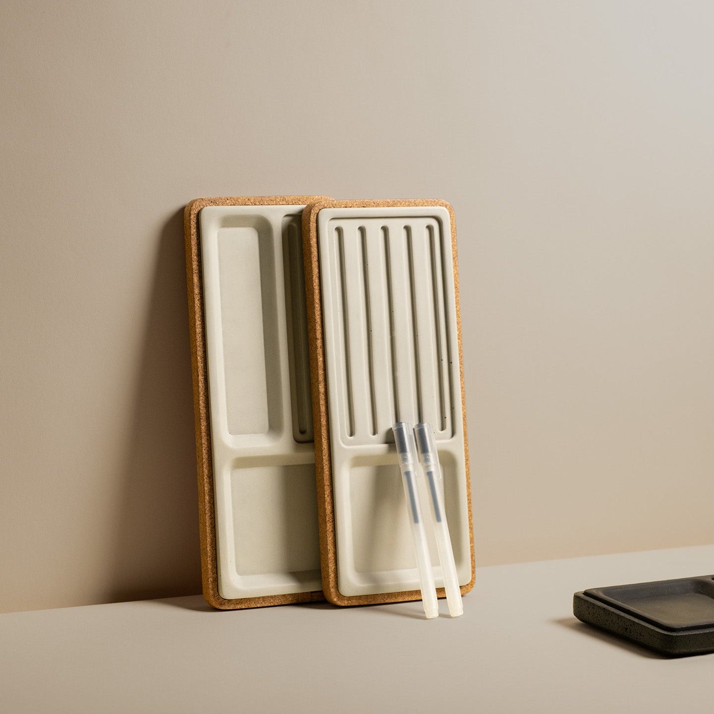 Modhaus Studio Desk Trays leaned up agains a beige wall