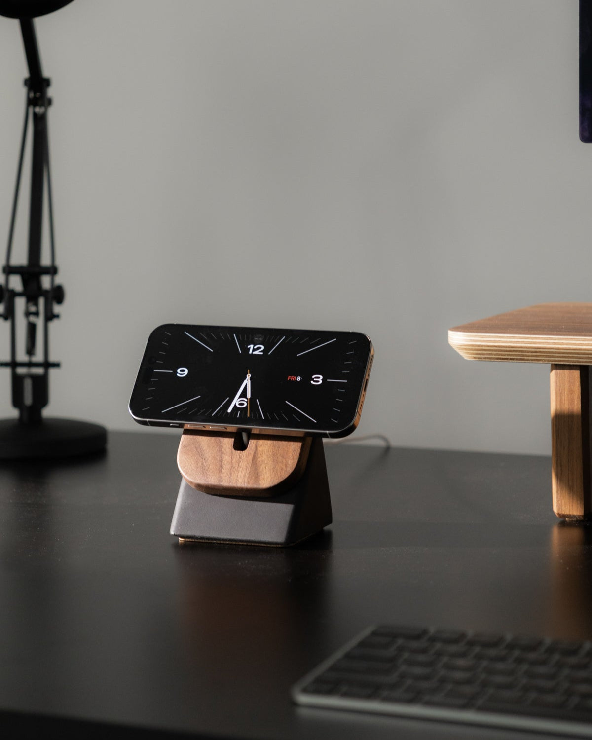 iPhone on a wooden and concrete magsafe phone stand