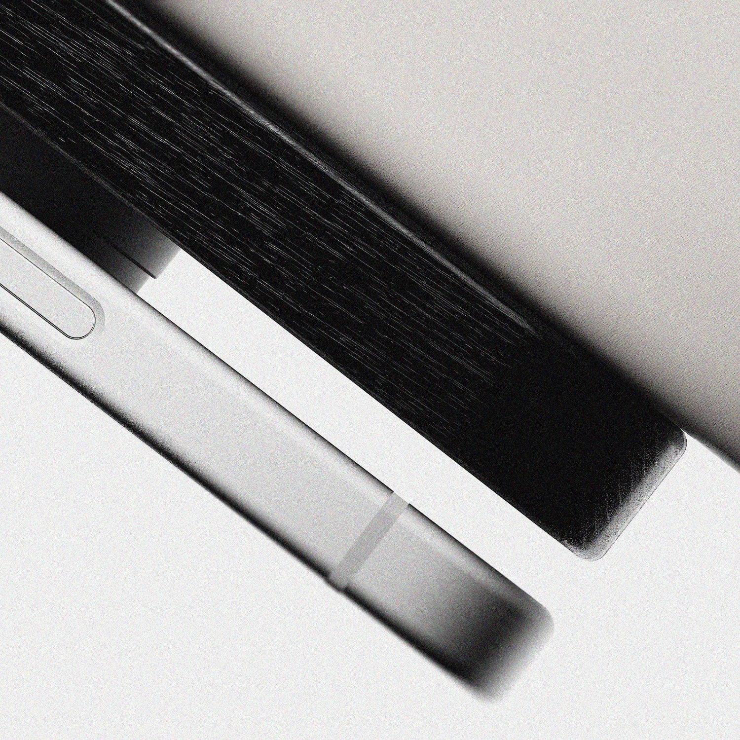 Close up of the upright wireless phone charger, displaying solid wood and cast concrete