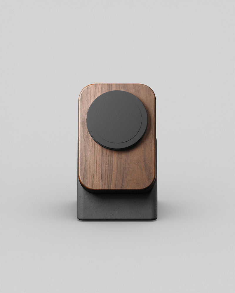 A modern wireless phone charger called the Upright By Modhaus. Wood and concrete charging stand on a light background