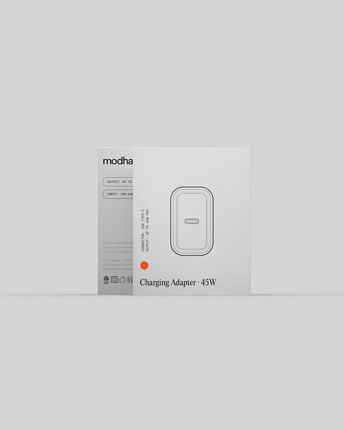 A white product box for a modhaus Charging Adapter - 45W, featuring a minimalist illustration of the charging adapter on the front, set against a clean, light gray background.