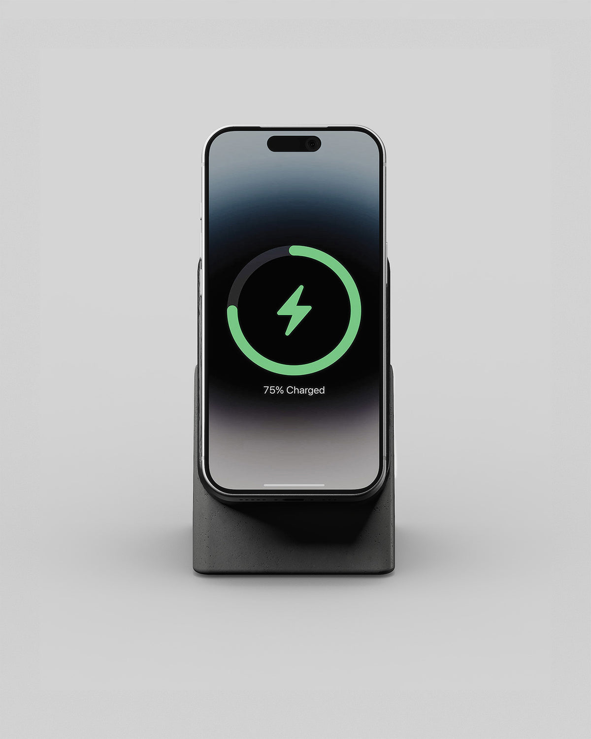 Upright wireless charging stand in black wood and charcoal concrete, front view with a smartphone charging
