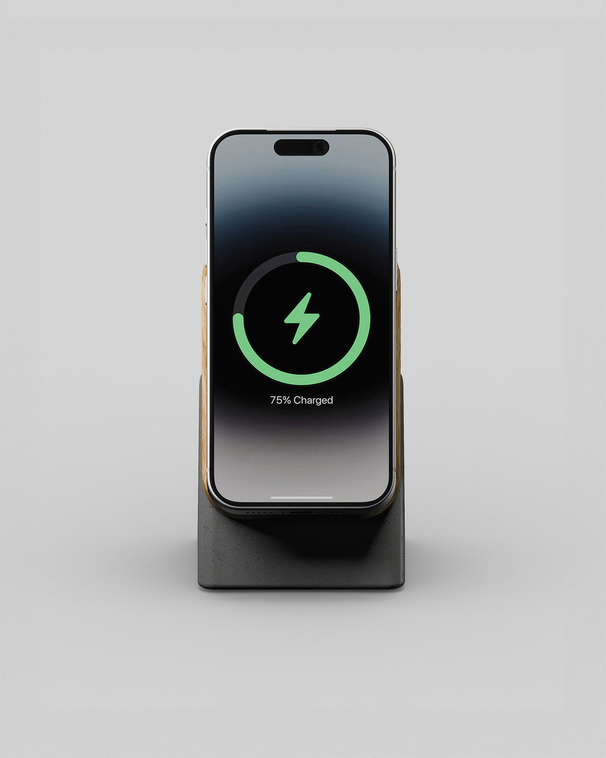 Upright wireless charging stand in oak and charcoal concrete, front view with a smartphone charging