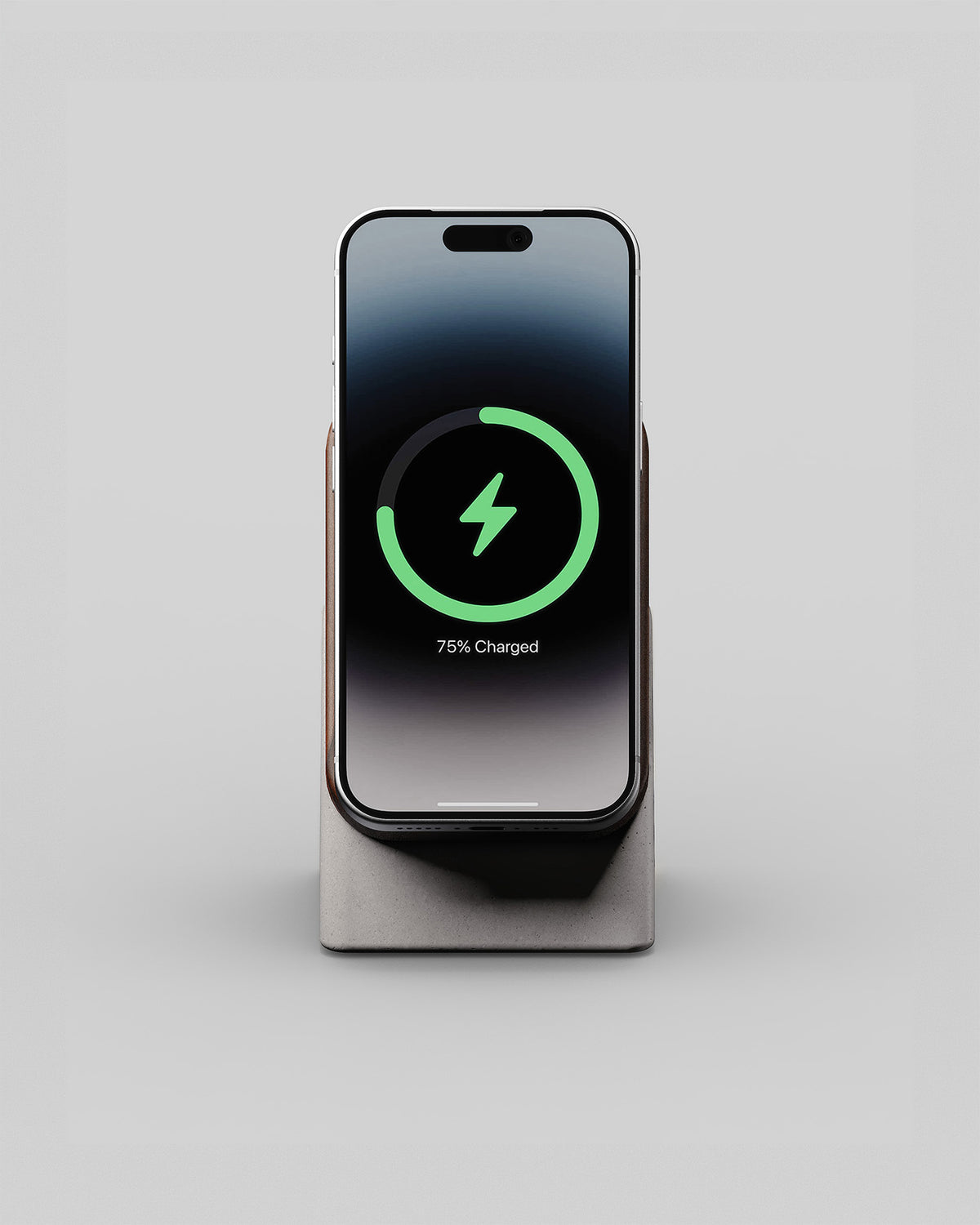 Upright wireless charging stand in walnut and stone concrete, front view with a smartphone charging