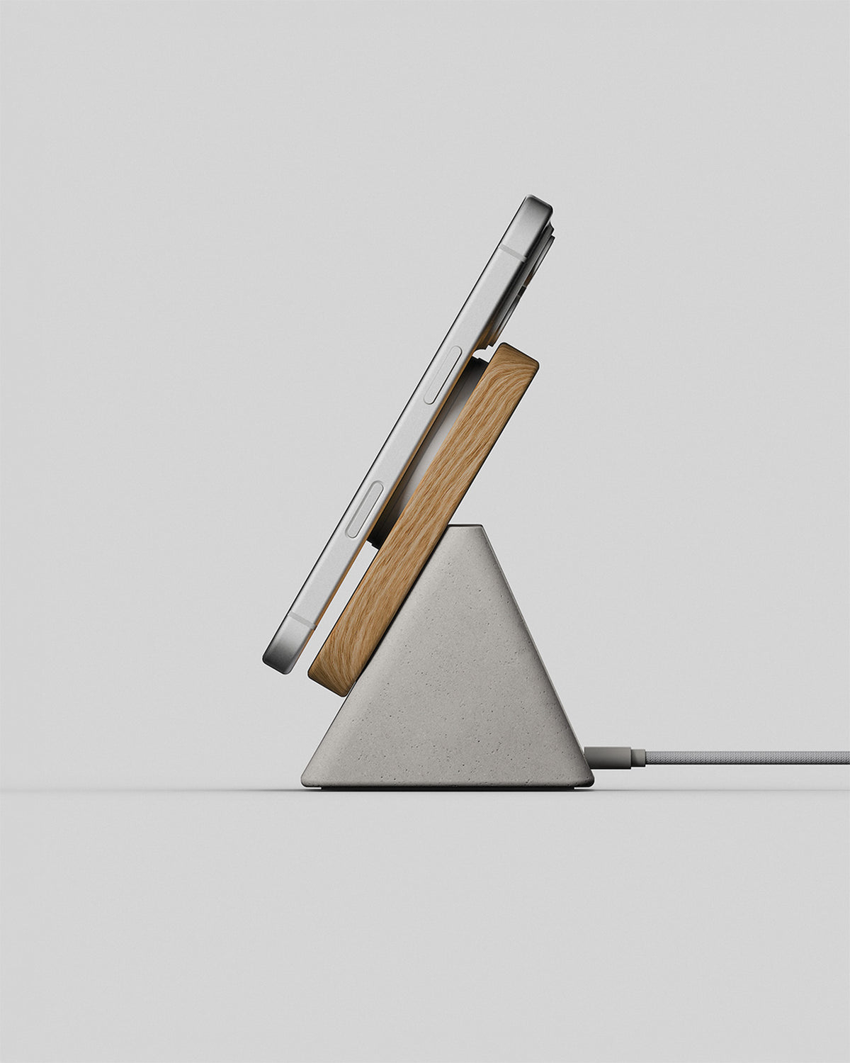 Upright wireless charging stand in oak and stone concrete, side view