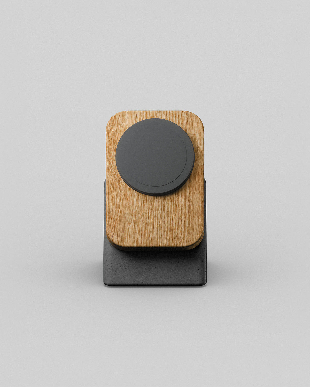 Upright wireless charging stand by Modhaus in oak and charcoal concrete, front hero view on a light background