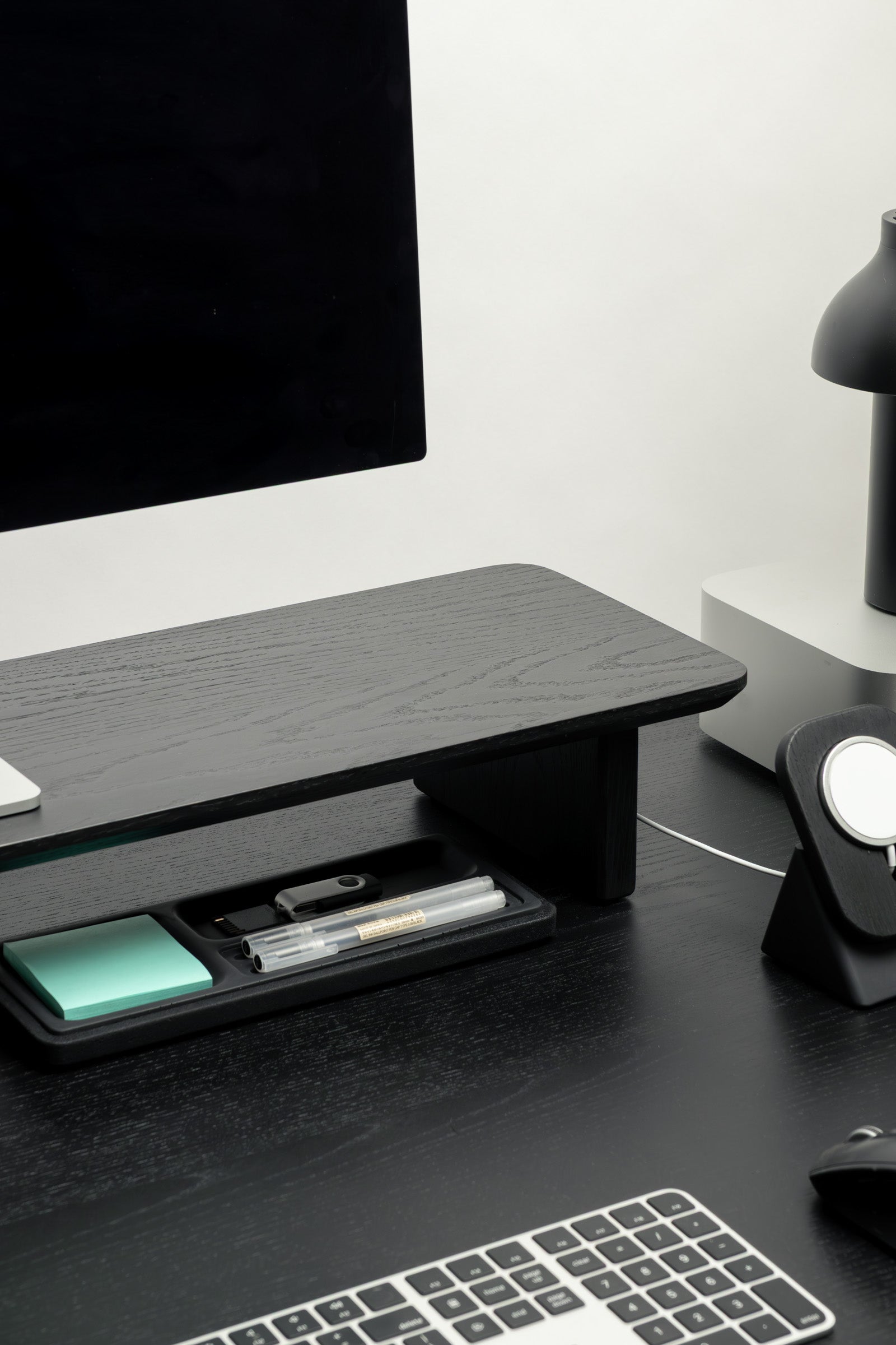 Black desk organizer on a desk with a computer monitor, keyboard, and mouse.