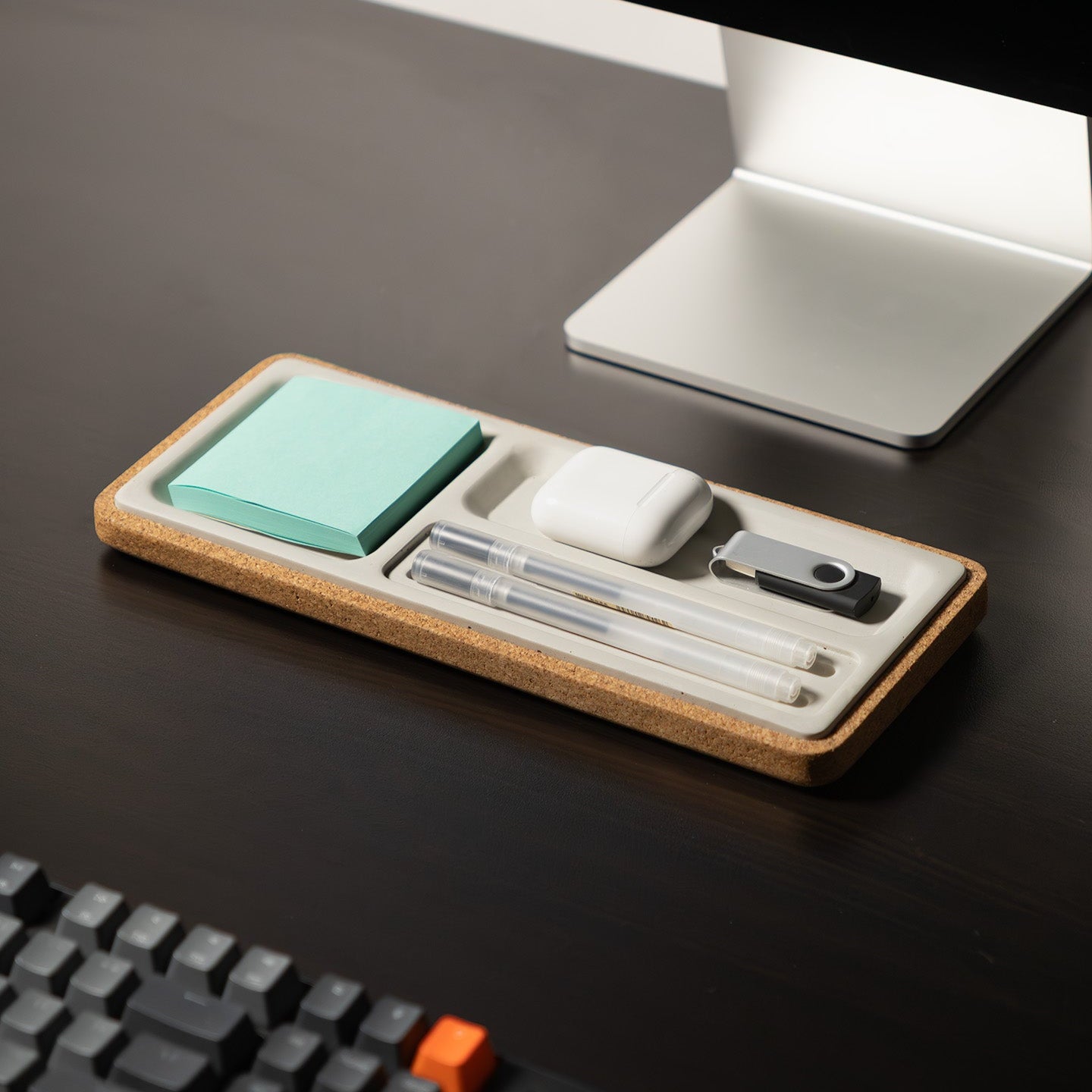 Desk organizer with stationery items on a desk next to a computer monitor and keyboard.