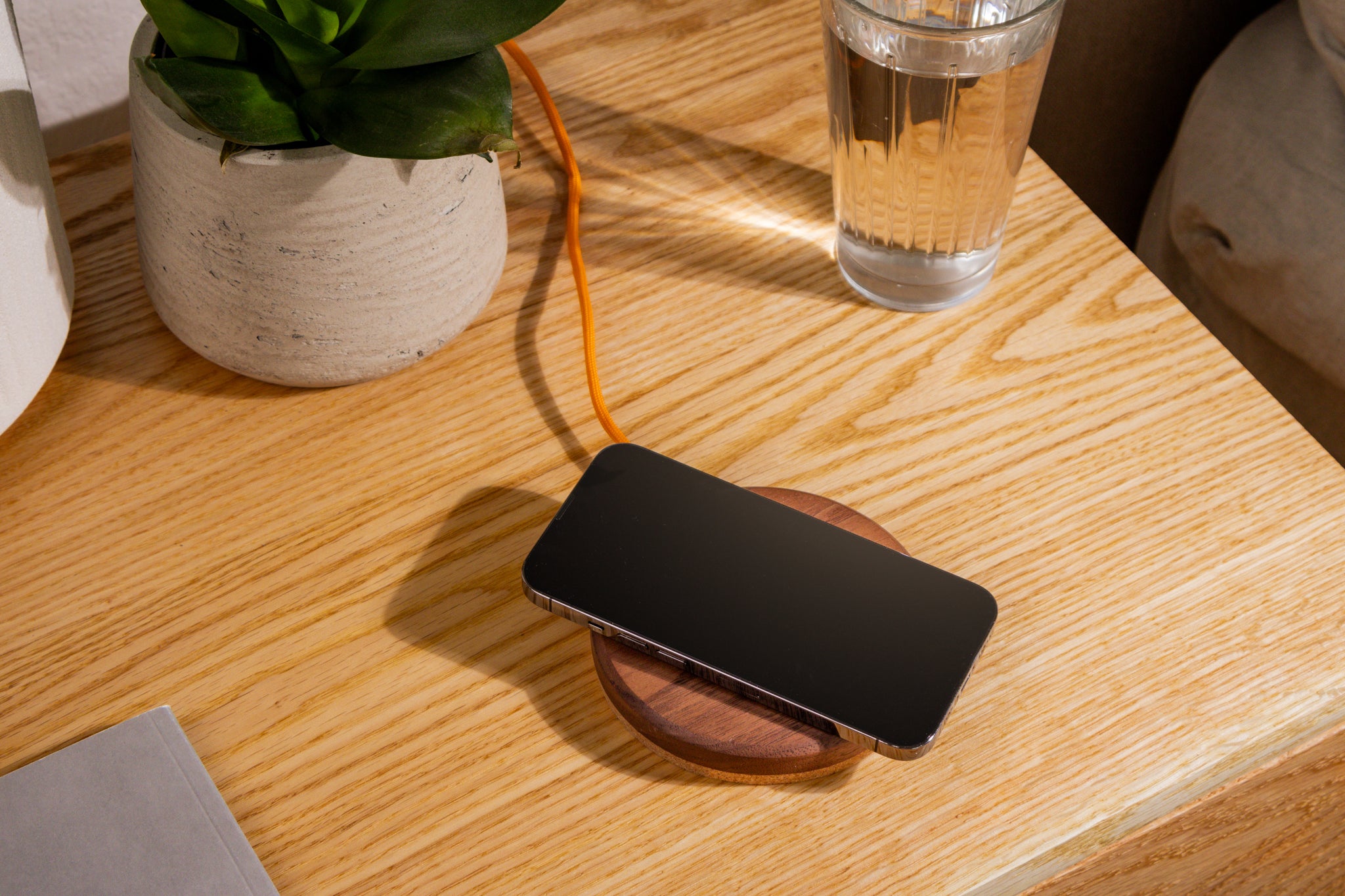 Modhaus wireless charging pad on a nightstand