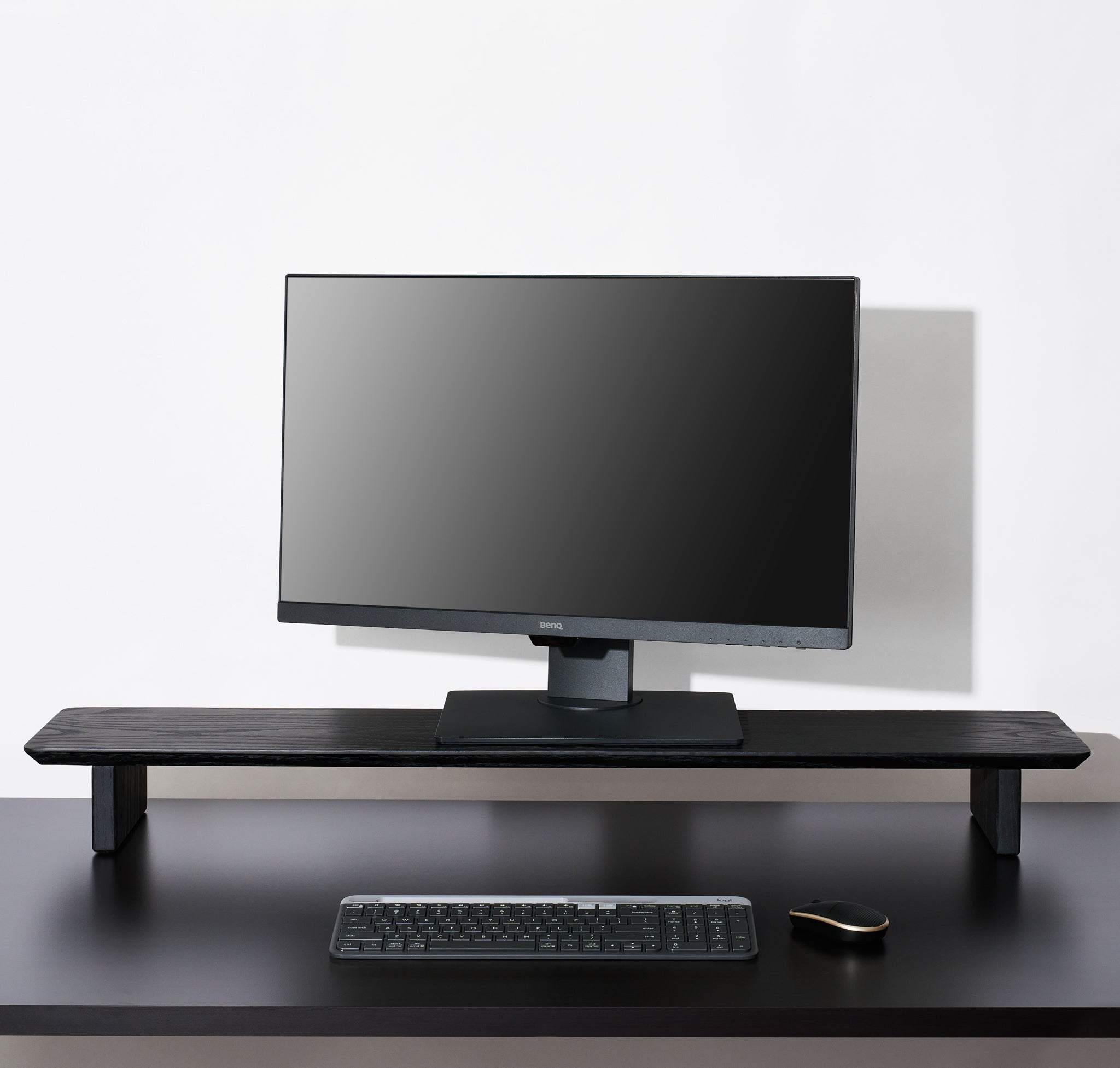 A large Black desk shelf large enough to support double monitors