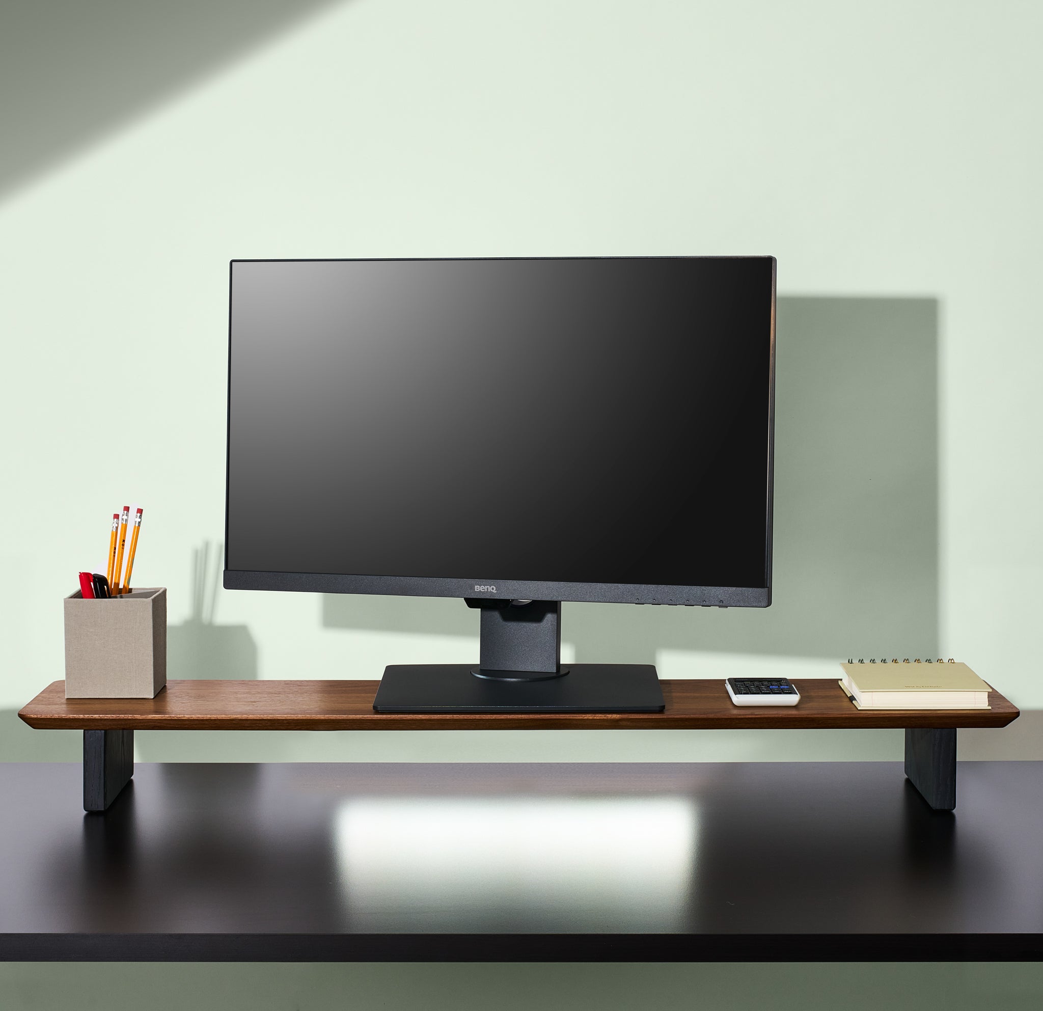 A large walnut desk shelf with other workspace accessories