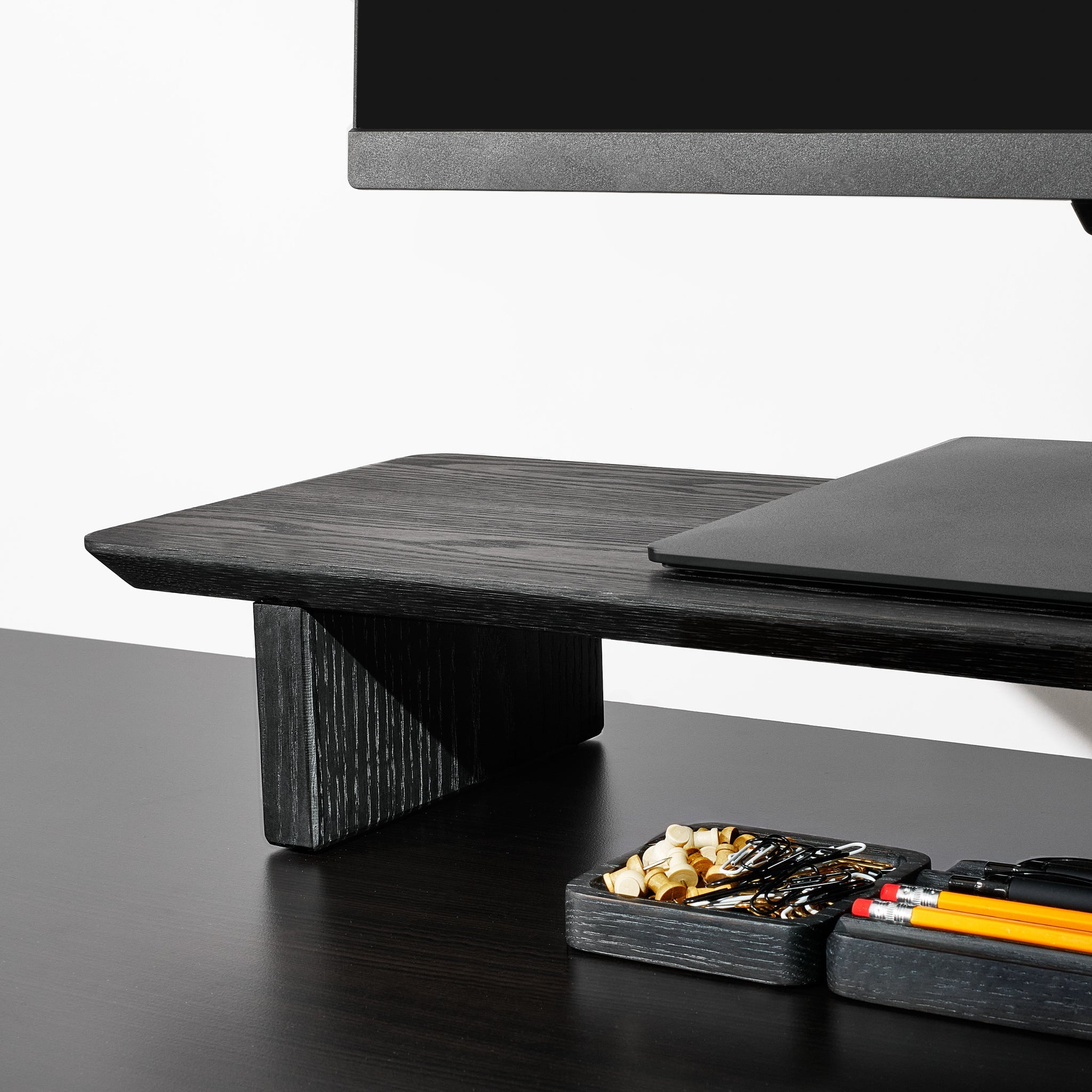 Black desk shelf details, with noticeable grain highlights